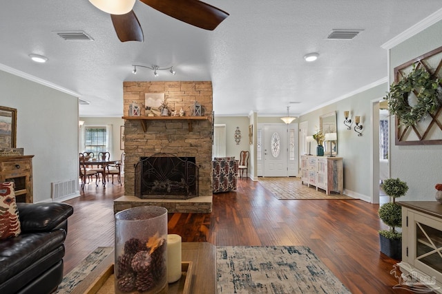 living room featuring crown molding, dark wood-type flooring, and a fireplace