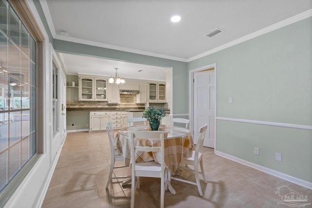 dining space with a notable chandelier and ornamental molding