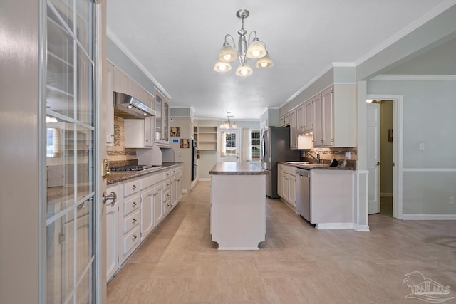 kitchen with a notable chandelier, stainless steel appliances, a center island, and white cabinets