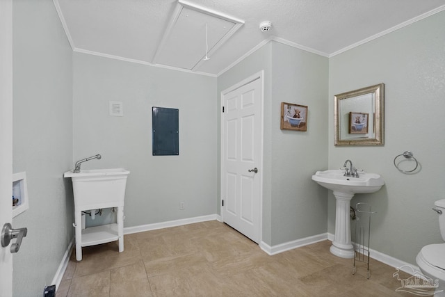 bathroom with ornamental molding, toilet, and electric panel