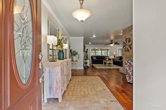 entryway featuring crown molding, ceiling fan, and hardwood / wood-style flooring