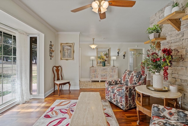 sitting room with wood-type flooring, ceiling fan, and crown molding