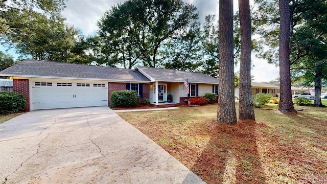 single story home featuring a garage and a front yard