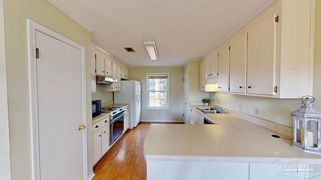 kitchen featuring sink, light hardwood / wood-style flooring, white cabinetry, stainless steel electric stove, and kitchen peninsula