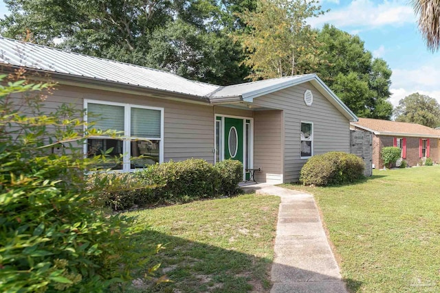 2322 Silversides Loop, Pensacola, FL 32526 - view of front of home with a front yard and metal roof