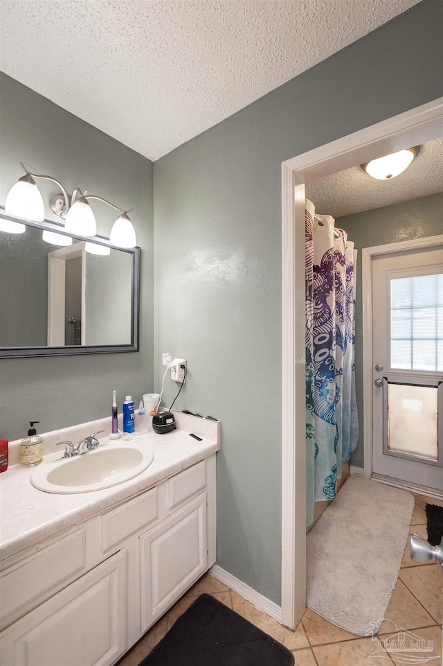 2322 Silversides Loop, Pensacola, FL 32526 - full bath with tile patterned flooring, a textured ceiling, vanity, a shower with shower curtain, and baseboards