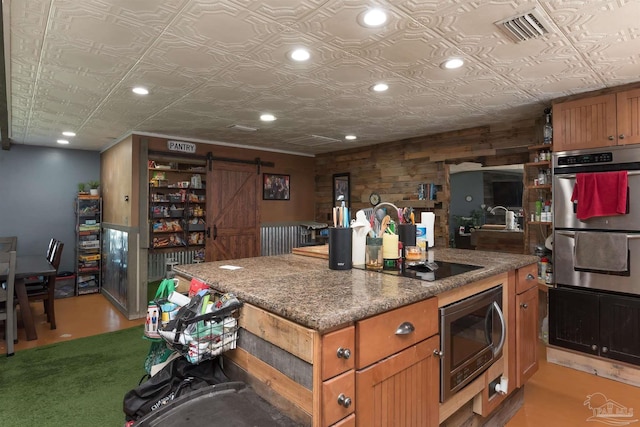 2322 Silversides Loop, Pensacola, FL 32526 - kitchen featuring stainless steel appliances, a barn door, an ornate ceiling, recessed lighting, and brown cabinetry