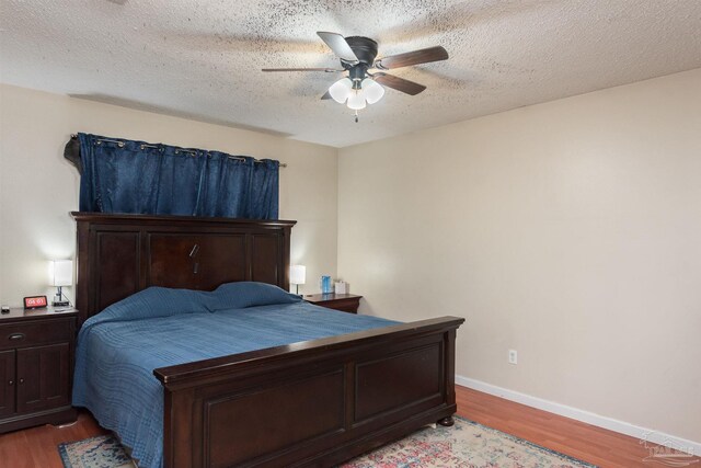 2322 Silversides Loop, Pensacola, FL 32526 - bedroom with light wood-style flooring, ceiling fan, baseboards, and a textured ceiling