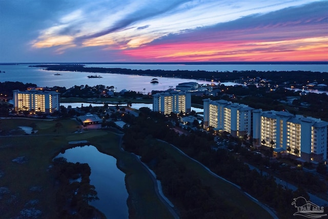 aerial view at dusk with a water view and a city view