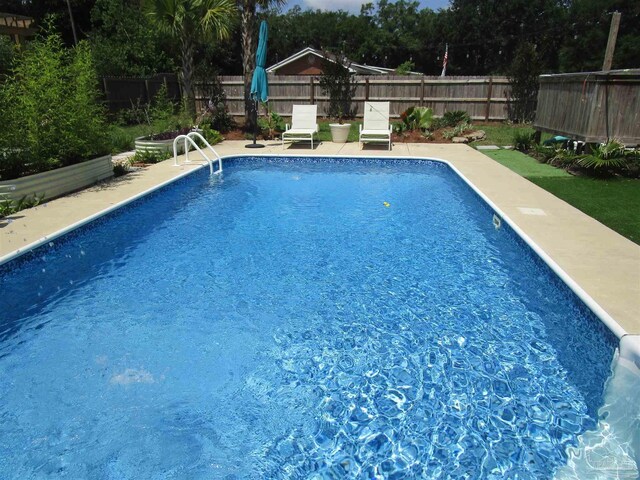 view of pool featuring a fenced backyard and a patio