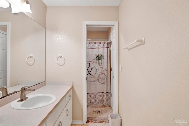 bathroom with vanity, curtained shower, and tile patterned flooring