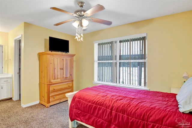 bedroom featuring ensuite bathroom, carpet flooring, and ceiling fan