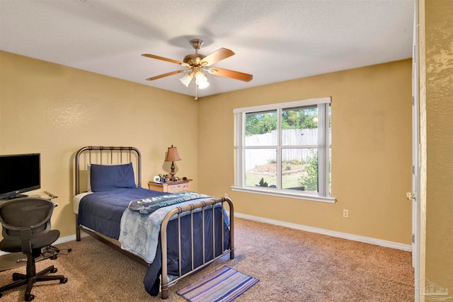 bedroom featuring a textured ceiling, carpet, and ceiling fan