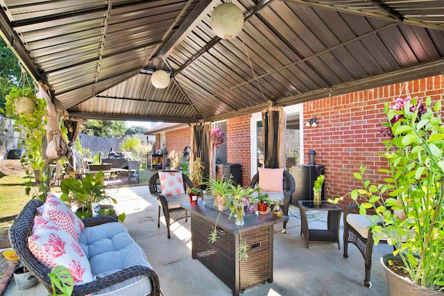 view of patio / terrace with a gazebo, ceiling fan, and an outdoor hangout area