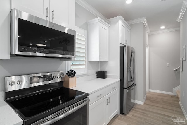 kitchen with light wood-style flooring, white cabinets, stainless steel appliances, light countertops, and ornamental molding