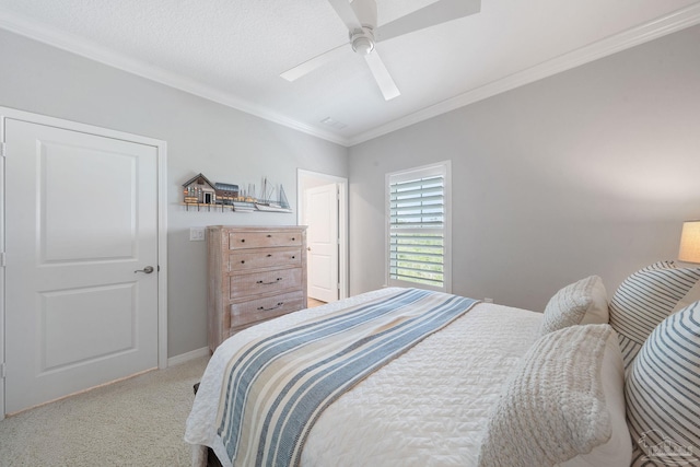carpeted bedroom featuring baseboards, ceiling fan, and crown molding