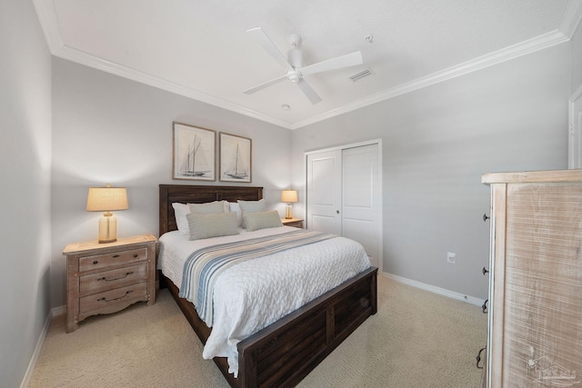 bedroom featuring a closet, light carpet, baseboards, visible vents, and crown molding