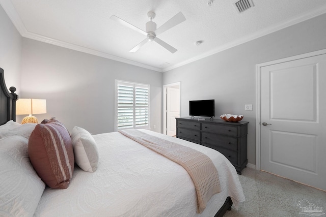bedroom featuring light colored carpet, ceiling fan, baseboards, visible vents, and crown molding
