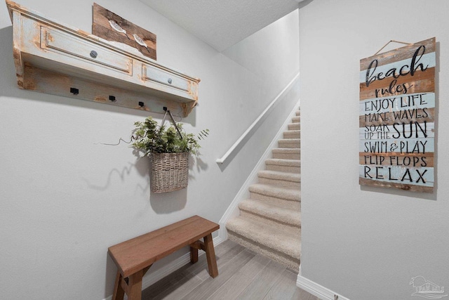 mudroom with light wood-style flooring and baseboards