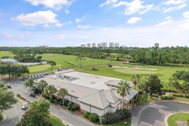 aerial view featuring a view of city, a water view, and view of golf course