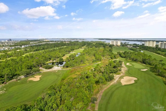 drone / aerial view featuring golf course view and a water view