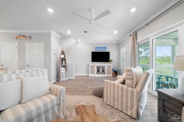 living room featuring recessed lighting, light wood-style floors, ornamental molding, a ceiling fan, and a textured ceiling