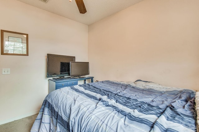 carpeted bedroom featuring a textured ceiling and ceiling fan