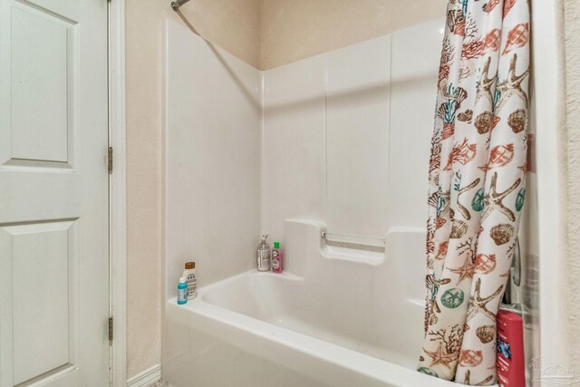 bathroom with shower / bathtub combination with curtain