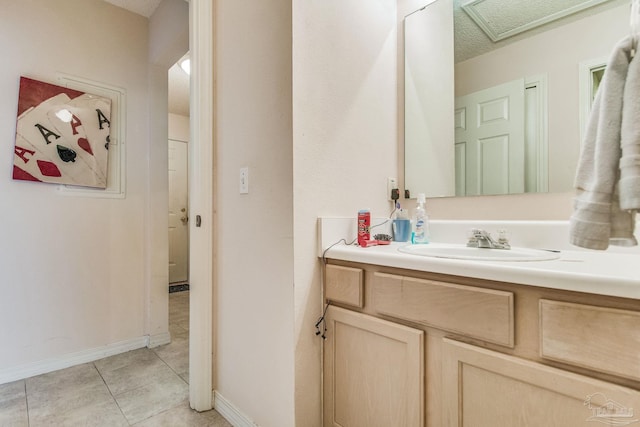 bathroom with vanity, a textured ceiling, and tile patterned flooring