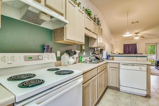 kitchen featuring vaulted ceiling, white appliances, light brown cabinetry, sink, and ceiling fan