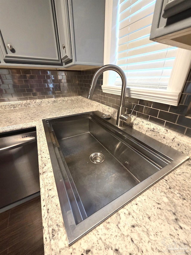 1836 Nestle Dr, Pensacola, FL 32534 - details with tasteful backsplash, gray cabinetry, a sink, dishwasher, and light stone countertops