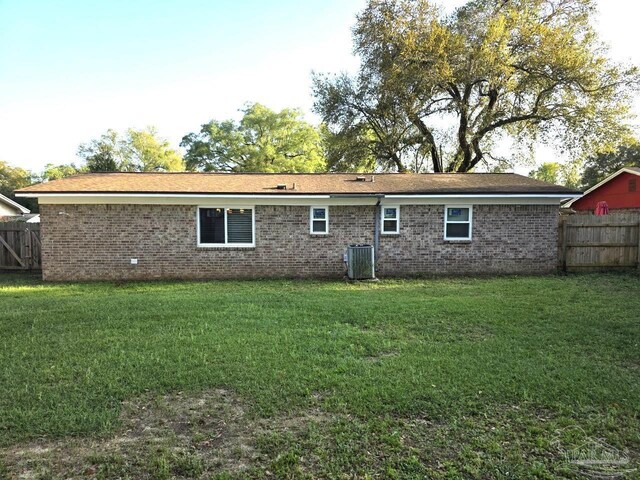 1836 Nestle Dr, Pensacola, FL 32534 - back of property featuring brick siding, central air condition unit, fence, and a yard