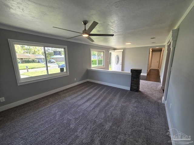 1836 Nestle Dr, Pensacola, FL 32534 - spare room featuring baseboards, a textured ceiling, dark carpet, and a ceiling fan