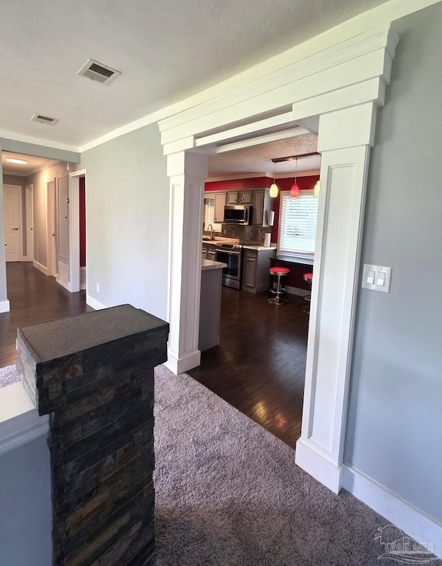 1836 Nestle Dr, Pensacola, FL 32534 - kitchen featuring decorative backsplash, light countertops, visible vents, appliances with stainless steel finishes, and dark wood-type flooring