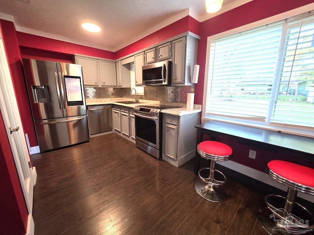 1836 Nestle Dr, Pensacola, FL 32534 - kitchen with tasteful backsplash, gray cabinetry, a sink, dark wood-style floors, and appliances with stainless steel finishes