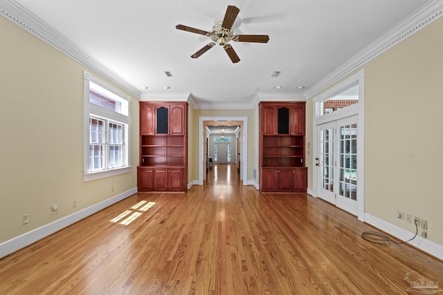 unfurnished living room with a ceiling fan, crown molding, light wood-type flooring, visible vents, and baseboards