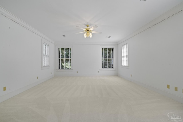 unfurnished room featuring baseboards, ceiling fan, crown molding, and carpet floors
