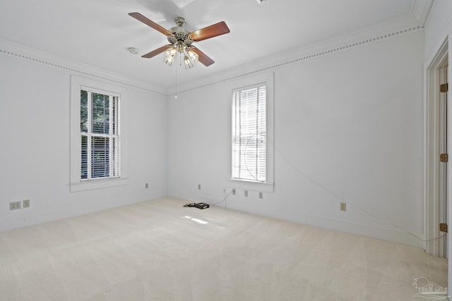 carpeted empty room featuring ceiling fan and crown molding