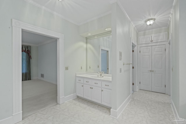 bathroom featuring baseboards, visible vents, vanity, and crown molding