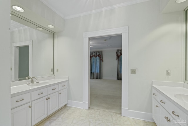 full bathroom with a sink, ornamental molding, two vanities, and baseboards