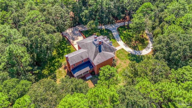 drone / aerial view with a wooded view