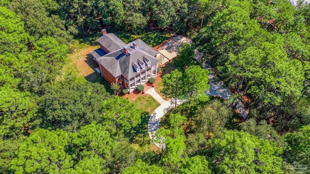 drone / aerial view with a wooded view