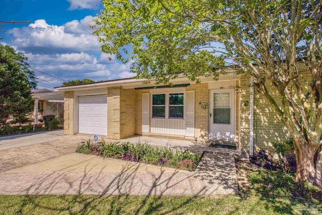 view of front facade featuring concrete driveway, brick siding, and an attached garage