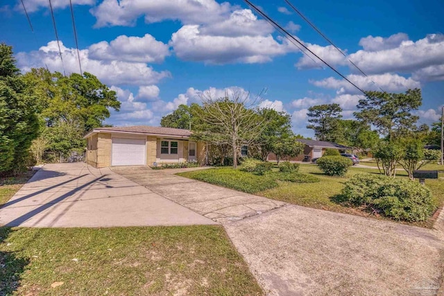 ranch-style house featuring a front yard, driveway, stucco siding, and an attached garage