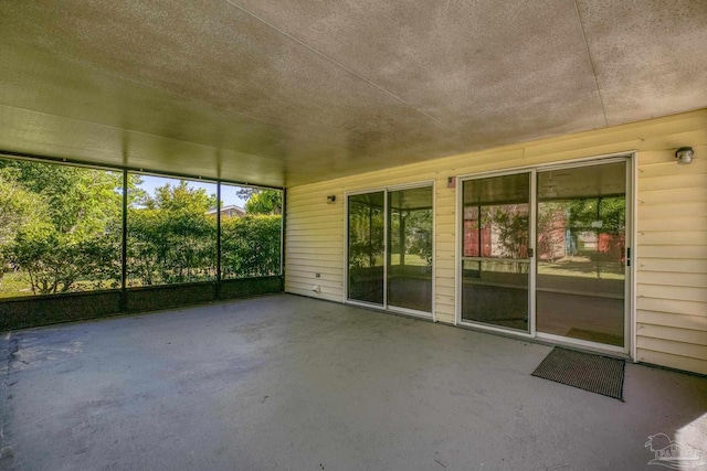 unfurnished sunroom featuring a wealth of natural light