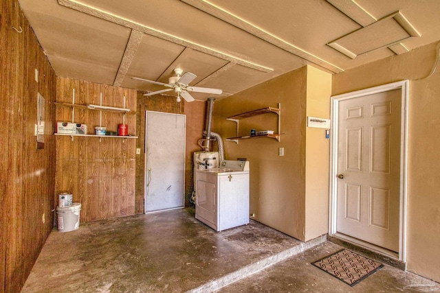 laundry area with wooden walls, independent washer and dryer, and a ceiling fan