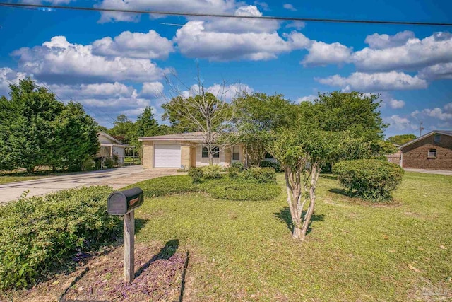view of front of house with driveway, a garage, and a front lawn