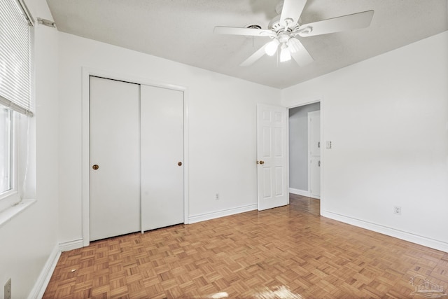 unfurnished bedroom with a closet, baseboards, and a ceiling fan