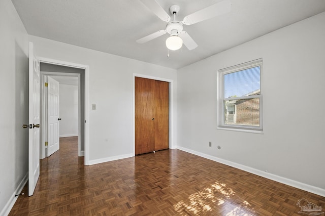 unfurnished bedroom featuring a closet, ceiling fan, and baseboards