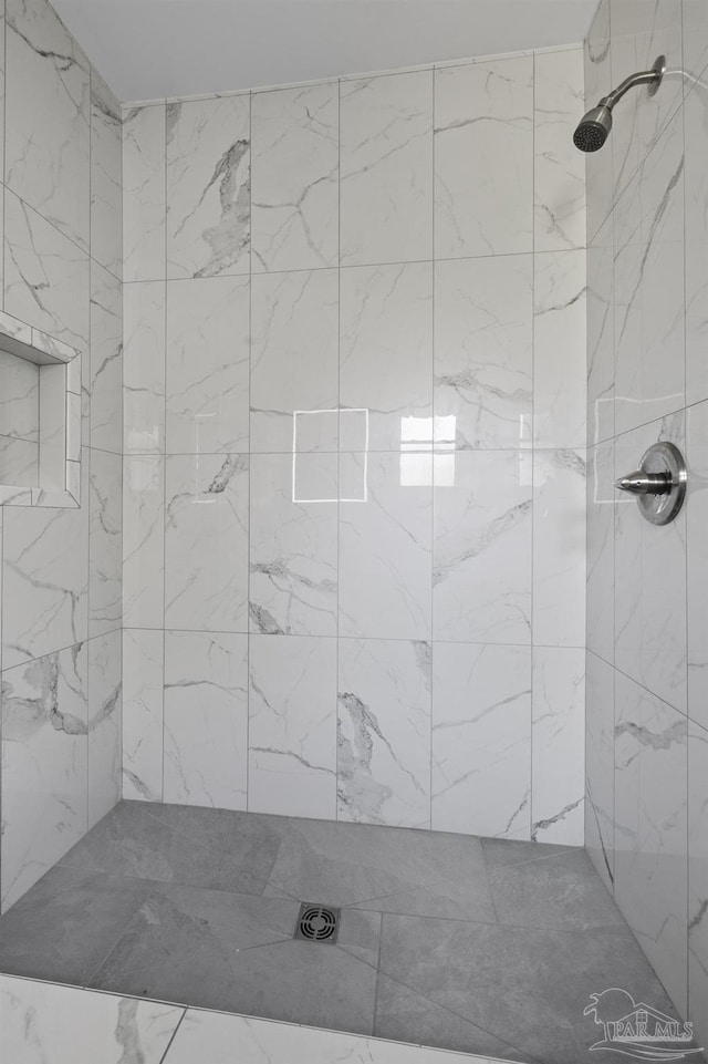 full bathroom with a tile shower
